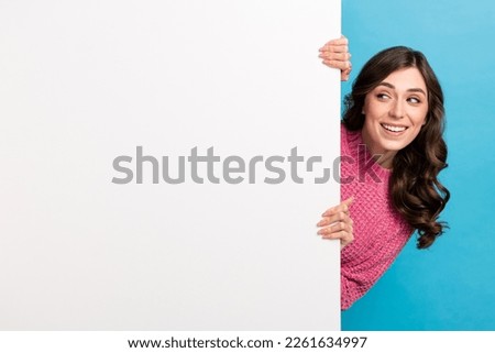 Photo of young playful hiding big poster looking mockup opening new menu restaurant cheap prices tasty food isolated on blue color background