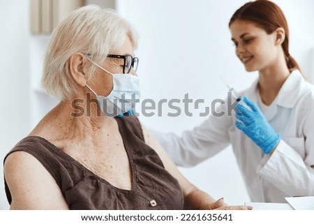 elderly woman wearing a medical mask immunization safety hospital