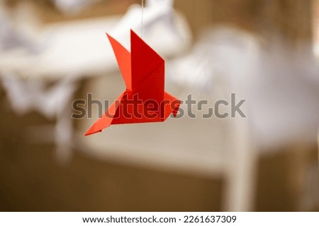 Japanese folded Origami cranes hanging on with strings. Hundreds handmade paper birds isolated with copy space. 1000 thousand crane tsuru sculpture topic. Symbol of peace, faith, health, wishes, hope Royalty-Free Stock Photo #2261637309