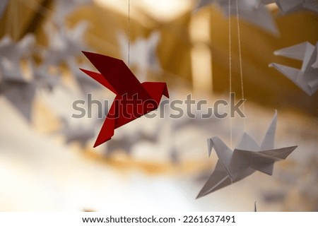 Japanese folded Origami cranes hanging on with strings. Hundreds handmade paper birds isolated with copy space. 1000 thousand crane tsuru sculpture topic. Symbol of peace, faith, health, wishes, hope Royalty-Free Stock Photo #2261637491