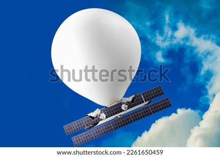 stratospheric balloon, complete with solar panels and cameras, travels at an altitude well above commercial air traffic in a blue sky Royalty-Free Stock Photo #2261650459