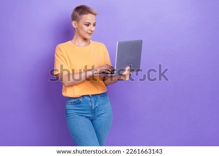Photo of pretty nice girl hold use netbook write email empty space isolated on violet color background