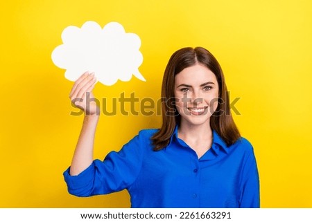 Photo of cheerful pretty lady wear blue stylish clothes hold white card isolated on yellow color background