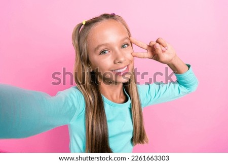 Selfie closeup photo of young beautiful cute nice pretty schoolgirl toothy smile cover face v-sign cool blogger facebook video isolated on pink color background