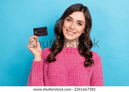 Photo of lovely cheerful lady wear stylish clothes hold plastic card offer proposition recommendation isolated on blue color background