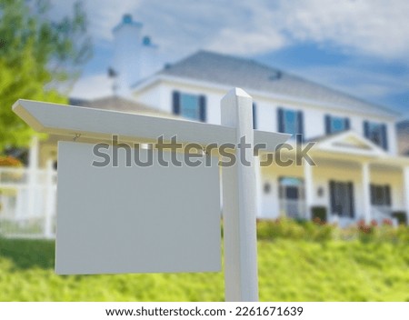 Blank Real Estate Sign in Front of New House.