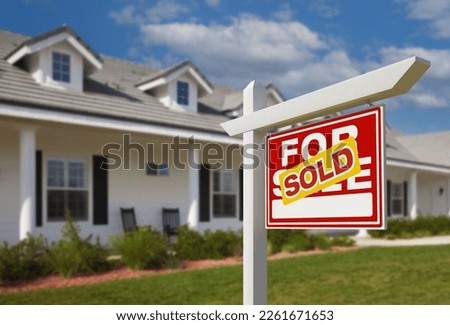 Sold For Sale Real Estate Sign in Front of New House.