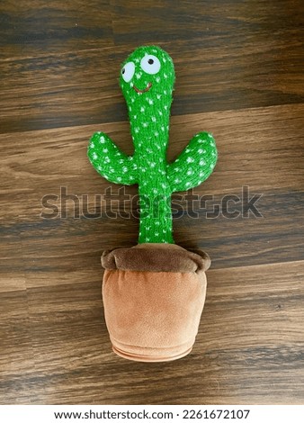 Cactus toy with a wooden background