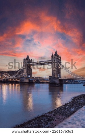 Tower Bridge London, sunset on the famous bridge, warm colors in the sky, lighting in the tower and view of the river Thames, at sunset Royalty-Free Stock Photo #2261676361