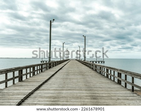 A wide empty pier with street lights in Texas Royalty-Free Stock Photo #2261678901