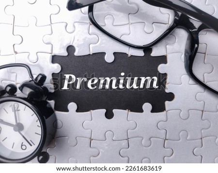 Glasses and clock with the word Premium on a black background