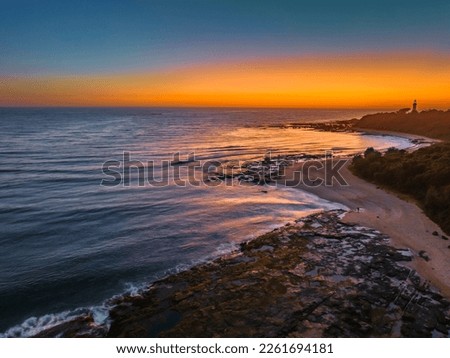 Aerial sunrise seascape from the sheltered bay of Cabbage Tree Harbour at Norah Head, NSW, Australia. Royalty-Free Stock Photo #2261694181