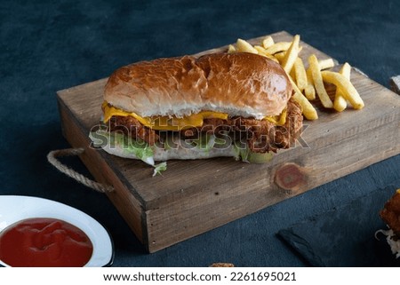 crispy cheese chicken patty burger with fries and dips meal