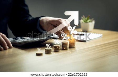 interest rates and dividends, Business people calculate and higher graphs and percentages investment returns, stock return income, retirement Compensation fund, investment, dividend tax Royalty-Free Stock Photo #2261702113