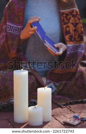 Card deck, Candles, divination in female hands. 