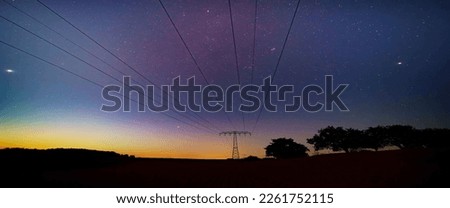 night starry sky and power lines european energy crisis 2022 blackout concept Royalty-Free Stock Photo #2261752115