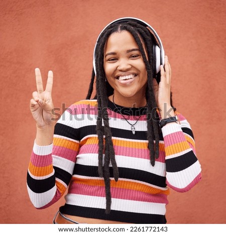 Portrait, headphones and black woman with peace sign isolated on orange wall for gen z music or mental health. Young person or v hands of youth listening to audio 5g technology or streaming services