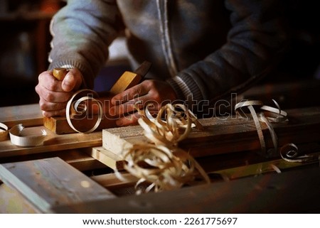 Plane jointer carpenter or joiner tool and wood shavings. Woodworking tools wooden table. Carpentry workshop Royalty-Free Stock Photo #2261775697