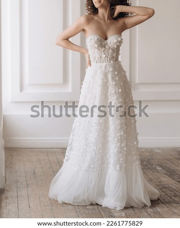 Front view of beautiful bride in the white wedding dress. Gorgeous wedding dress with stylish sleeves decorated with lace. Wedding lacy corset with cleavage Royalty-Free Stock Photo #2261775829