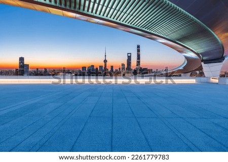 Empty square floor and bridge with city skyline at sunrise in Shanghai, China.