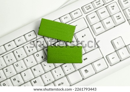 Colored wood cube with important message lying near keyboard. Main information written on notebook. School supplies. Multiple Assorted Collection Office Stationery.