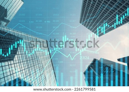 Real estate growth and investing concept with digital stock market growing candlestick and indicators on city skyscrapers tops bottom view, double exposure