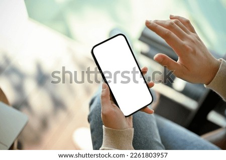 A woman using her smartphone, using mobile application or searching something on internet. smartphone white screen mockup, close-up hands image