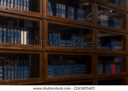 Classic wooden library with books. Education and study. Side view. Blurred. Royalty-Free Stock Photo #2261805601