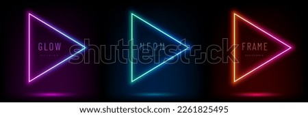 Set of pink-blue, red-purple, green illuminate neon triangle frames. Play sign. Abstract cosmic vibrant color geometric design. Collection of glowing neon lighting lines on top view dark background. Royalty-Free Stock Photo #2261825495