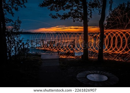 Spinning steel wool circles and having sunset on a backround.