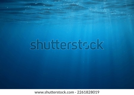 ocean underwater rays of light background, under blue water sunlight Royalty-Free Stock Photo #2261828019