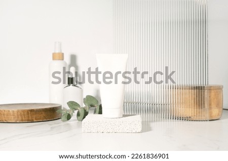White tube mockup for cosmetics product presentation on a bathroom table.