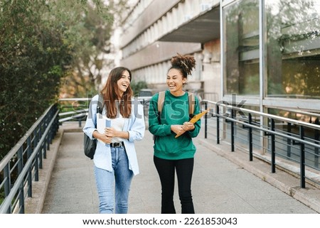 University student girl friends with learning books walking out School building