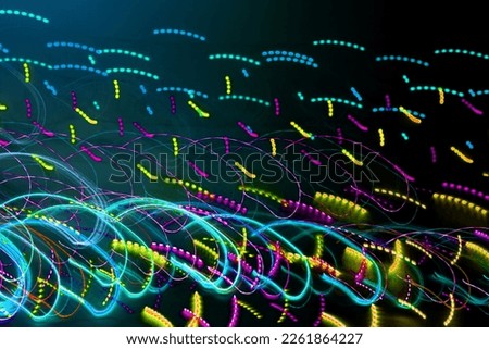 Blurred abstract background. Drawing with light, garlands with multi-colored LED bulbs, shooting while moving at a slow shutter speed.