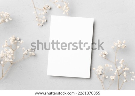 Wedding invitation card mockup with flowers, blank card flat lay with copy space Royalty-Free Stock Photo #2261870355