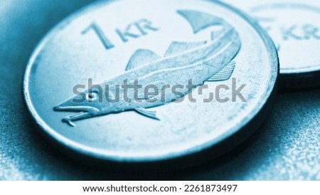 Icelandic 1 one crona coin closeup. National currency of Iceland. Light blue tinted money illustration for news about economy or finance. Loan and credit. Crown and central bank of Iceland. Macro Royalty-Free Stock Photo #2261873497