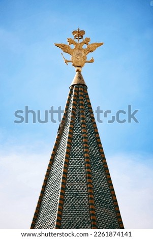 Kremlin tower spire with golden eagle. A two-headed eagle on top of a tower at the Red square, Moscow