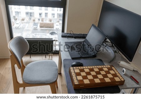 Writing and working on a laptop. Clean scene of the desk in office or room. Blank screen for mock up