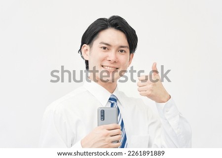 Asian businessman thumbs up gesture with the smartphone in white background