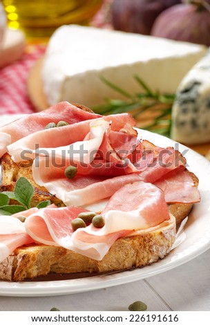 Grilled country bread with ham and capers