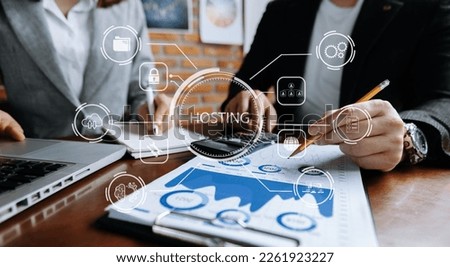 Web hosting concept, woman using computer laptop, tablet and presses his finger on the virtual screen inscription Hosting on desk, Internet, business, digital technology concept.

