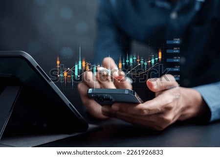 Businessmen investor think before buying stock market investment using smartphone to analyze trading data. investor analysis with stock exchange graph on screen. Financial stock market. Royalty-Free Stock Photo #2261926833