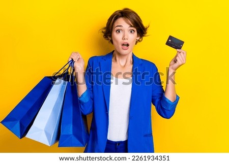 Photo of amazed agent lady hold shopping bags pay low price credit card isolated shine color background