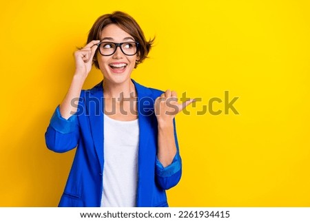 Photo of young funny surprised funny girl promoter business company proposition cheap clothes advertisement isolated on yellow color background Royalty-Free Stock Photo #2261934415