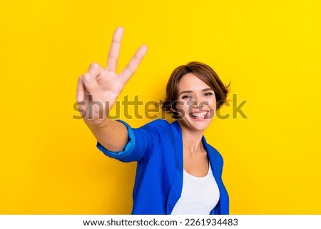 Photo of positive representative promoter lady feeling good friendly make v sign isolated bright color background
