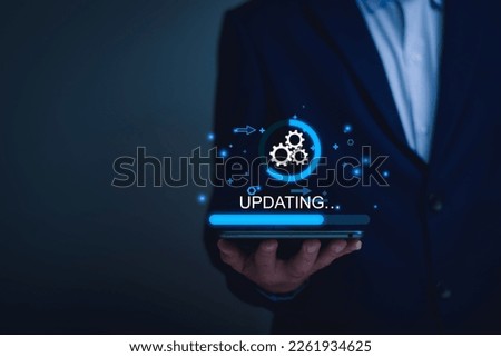 Operating system upgrade concept, installation app and software update process, modernize user equipment, update modern functions, developer released new version Improved security. User is downloading Royalty-Free Stock Photo #2261934625
