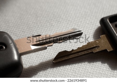 Photo of two different car keys on white background