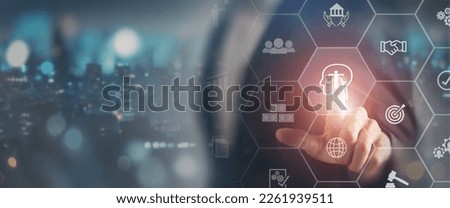 Business ethics concept. Ethical investment, sustianable development. Business integrity and moral culture. Businessman touching on ETHICS symbol on smart screening surrounded by ethical icons. Royalty-Free Stock Photo #2261939511