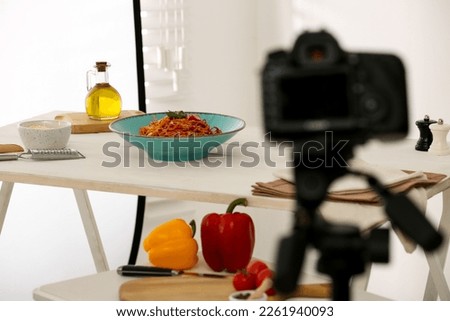 Professional camera and composition with spaghetti in photo studio, space for text. Food photography