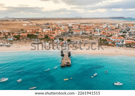 Pier and boats on turquoise water in city of Santa Maria, Sal, Cape Verde Royalty-Free Stock Photo #2261941515